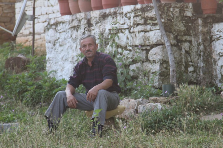 albanian man stone house